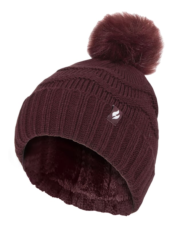 It's cold outside, but don't worry: we've got you covered. These Heat Holders Ladies Pom Pom Hats with Zig Zag knit patterns are the warmest winter hat you'll ever find. A hat that will be sure to keep out the cold! The high performance thermal yarn maximises warm air close to your body, and the Heatweaver technology makes sure that it stays there. So, even when it's freezing outside, you can be sure that this hat will keep your head nice and toasty. The Zig Zag knit design of this beanie is fun and comfortable while the pom pom adds a cute touch that makes this hat look even more fashionable than it already is! It comes in 4 traditional colours: Black, Wine, Navy & Cream. The thick and warm design is soft and comfortable, so you can wear it all day long without feeling any discomfort. Whether you're looking to feel comfortable or fabulous, this Zig Zag beanie hat is an essential addition to your Winter collection! These fashionable hats are made from: Outer: 100% Acrylic, Lining: 100% Polyester and are Ladies One Size fits all. They come in 4 traditional colours: Black, Wine, Navy & Cream and are Machine Washable.