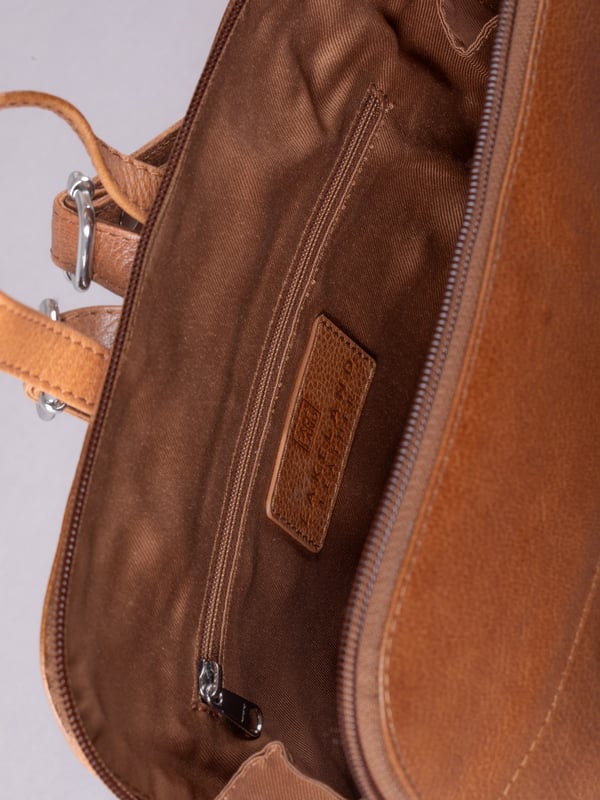 The Talkin handbag collection is a study in sleek sophistication, and this practical backpack is no exception. Crafted from soft premium leather, this classic style has plenty of space to ensure you can carry all your essentials with ease. The adjustable leather straps offer unparalleled comfort, and we've included a grab handle for convenient carrying.
