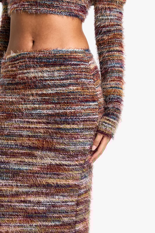 Striking striped knit pattern for eye-catching appeal
        Off-shoulder crop top design for a trendy, flirtatious look
        Figure-hugging maxi skirt silhouette to accentuate curves
        Long sleeves for versatile wear across seasons
        Coordinated two-piece set for effortless style
    
    Make a bold statement with this captivating tall striped knit maxi skirt set. The off-shoulder crop top adds a flirty touch, while the form-fitting maxi skirt creates a sleek, elongated silhouette. Perfect for those who love to stand out, this ensemble can be dressed up or down for various occasions. For a casual daytime look, pair with trainers and a denim jacket. When the evening calls for something more glamorous, swap the trainers for heeled boots and add statement earrings. The versatile knit fabric ensures comfort throughout the day, making it ideal for family gatherings or brunches with friends. Layer with a leather jacket for cooler evenings or style with a clutch bag for a night out. This Boohoo set is a must-have for the fashion-forward woman who wants to turn heads while staying comfortable and on-trend.