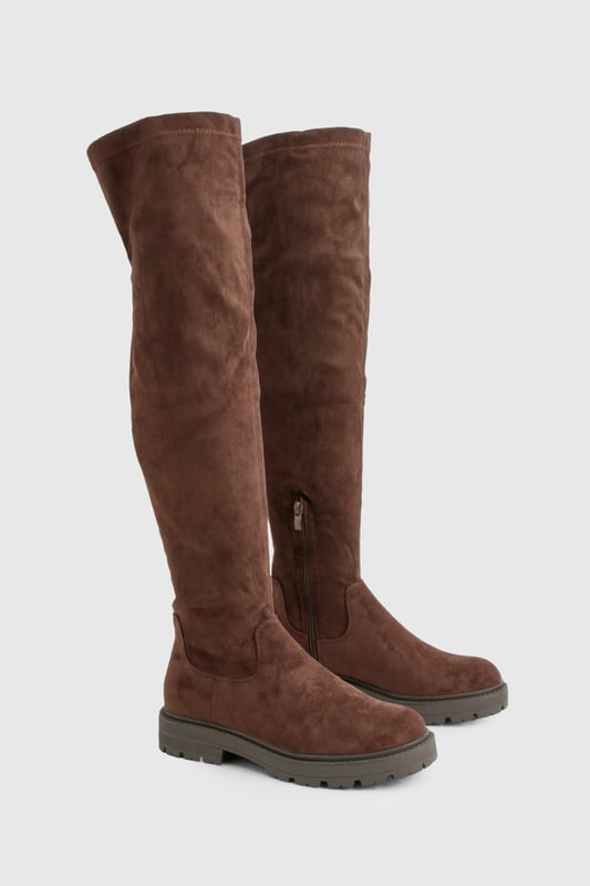 Knee-high boots with chunky silhouette
        Faux suede upper for a luxe look
        Flat heel (0-2cm) for all-day comfort
        Robust cleated sole for enhanced grip
        Side zip closure for easy on-and-off
    
    Make a bold statement with these eye-catching knee-high boots from Boohoo. The chunky silhouette and faux suede finish create a striking look that's perfect for the fashion-forward trendsetter. Designed with comfort in mind, the flat heel allows for effortless all-day wear, while the cleated sole provides excellent traction on various surfaces. Style these versatile boots with a flowy midi dress and oversized jumper for a chic autumn ensemble, or pair them with skinny jeans and a leather jacket for an edgy night-out look. Whether you're heading to a casual family gathering or a day out with friends, these boots will keep you on-trend and comfortable from dawn to dusk.