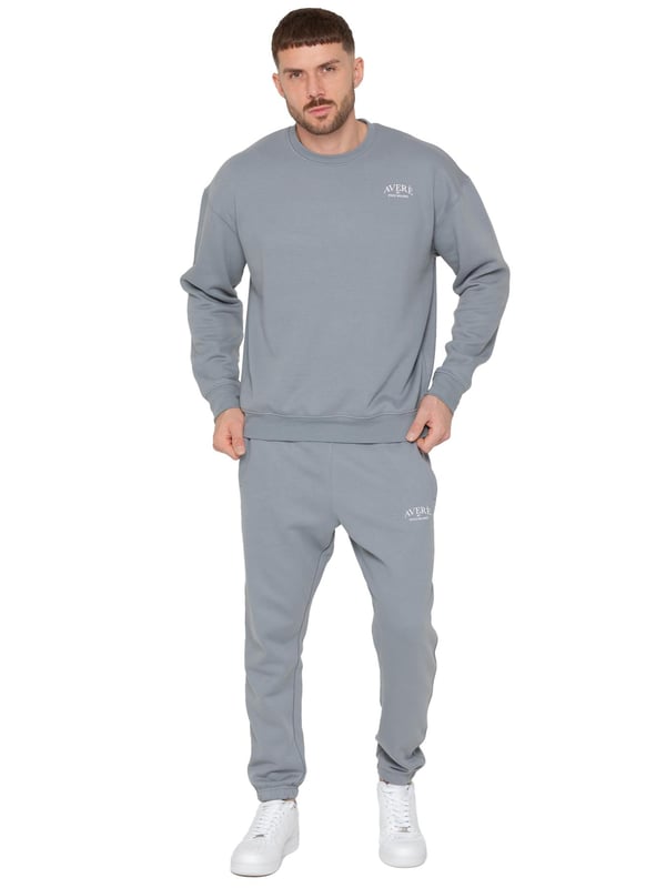 Das Averè by Enzo Milano Herren Oversized Sweatshirt Trainingspak ist ein stilvolles und bequemes Set, das aus einem Oversized Sweatshirt und Regular Fit Jogginghosen besteht. Das Sweatshirt bietet eine entspannte Passform mit langen Ärmeln, einem gerippten Rundhalsausschnitt und Bündchen für einen klassischen Look. Hergestellt aus weichem Stoff und Fleecefutter, verfügt es über ein dezentes Averè-Logo auf der Brust und eine schlichte Rückseite für Einfachheit. Die Jogginghosen haben einen elastischen Bund mit verstellbaren Kordelzügen, gerippte Knöchelbündchen und Seitentaschen sowie ein kleines Averè-Logo für einen stylischen Akzent. Perfekt zum Entspannen oder für den Alltag, kombiniert dieses Trainingsanzug Komfort mit modernem Design.