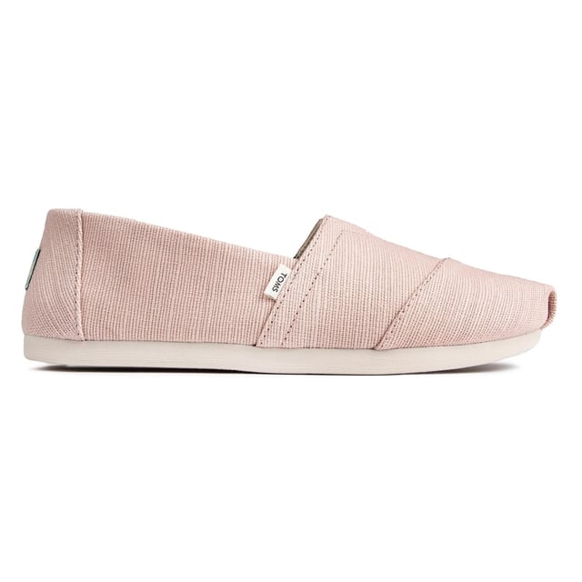 Step into effortless style and comfort with these classic slip-on plimsolls.

Crafted with care and attention to detail, these plimsolls feature a charming pink canvas upper that adds a touch of femininity to your everyday look. The slip-on design allows for easy wear and removal, while the elasticated V-panel ensures a secure fit and flexibility.

The Toms Alpargatas Slip-On Plimsolls prioritize comfort. The cushioned insole provides softness and support, making them perfect for all-day wear. Whether you're running errands, exploring the city, or simply lounging around, these plimsolls keep your feet feeling comfortable and at ease.

The durable canvas construction of these plimsolls ensures longevity and withstands daily wear. The rubber outsole offers reliable traction on various surfaces, providing stability and grip with every step.

Not only do these plimsolls prioritize comfort and durability, but they also embody Toms' commitment to giving back. With every purchase, Toms helps improve the lives of people in need by providing shoes, sight, water, and safe birth services to communities around the world.

In addition to their comfort and social impact, the Toms Alpargatas Slip-On Pink Canvas Women's Plimsolls (Model: 10016522) showcase a versatile design that effortlessly complements your casual outfits. The pink canvas upper adds a pop of color and pairs well with a range of looks, from jeans and shorts to skirts and dresses.