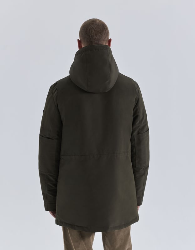 This khaki parka has high collar, hood, long sleeves and multi-pockets with drawstrings to tie at hood, concealed zip and press stud fastening under placket.