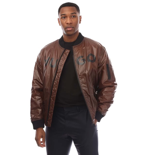 Mens HUGO Byler2431 Jacket in brown.- Ribbed bomber style collar.- Branded full front zip opening.- Two press stud entry pockets.- Zip entry pocket situated on the upper left sleeve.- Signature HUGO logo is printed on the chest.- All over padded design.- Ribbed cuffs and hem.- 100% Polyamide.- Ref: 50521233890