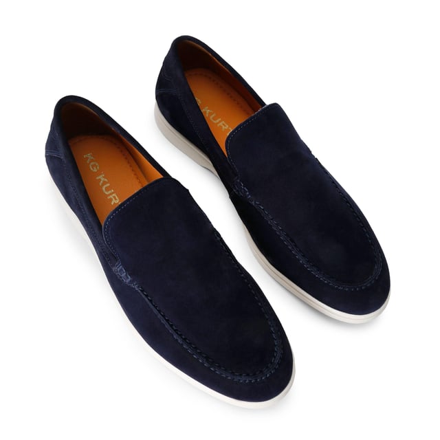This KG Kurt Geiger Ryan is a navy suede slip on loafer with sleek upper. There is embossed branding on the back of the ankle.