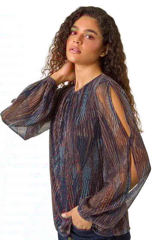 Shimmer Plisse Top from Roman. Unleash your style with our eye-catching geometric print plisse top, perfect for the Autumn Winter season. The classic round neckline and shirred cuffs offer a sophisticated touch, while the soft, shimmering fabric adds a hint of glamour. Pair with faux leather pants and ankle boots for a trendy party outfit!