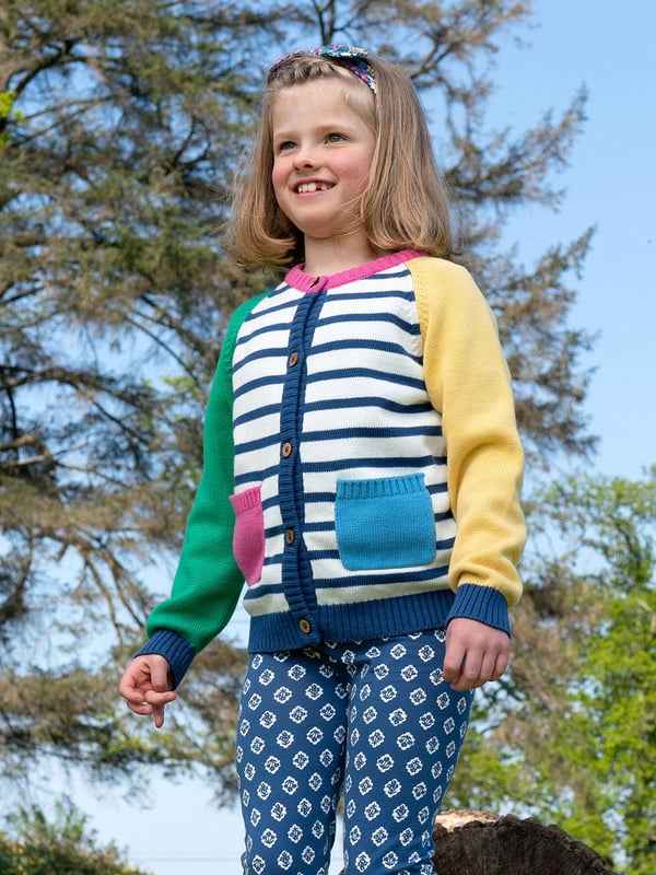 100% organic cotton | Proud to be certified to the Global Organic Textile Standard (GOTS) | Cream and navy blue knitted stripe | Featuring contrast colour sleeves, pockets and neckline | Midweight 7-gauge plain knit | Coconut button fastening | Contrast front pockets | Long sleeved | Round neck | Made in India | Machine washable at 40 degrees, or at 30 degrees to be kinder to the planet