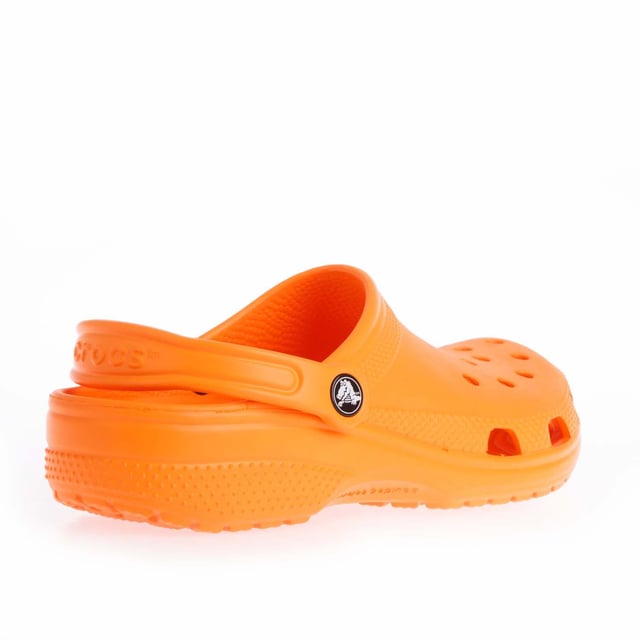 Juniors Crocs Classic Clogs in orange.- Slip on fastening.- Ventilation ports add breathability and help water and debris drain away.- Heel strap.- Fully molded Croslite™ material for signature Crocs comfort.- Lightweight  non-marking soles.- Ref: 20699183A
