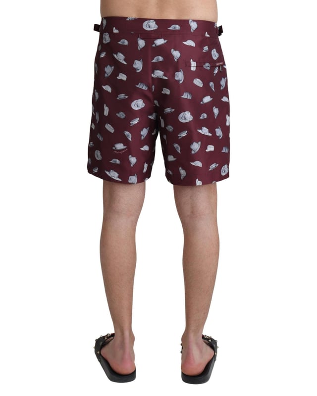 Absolutely stunning 100% Authentic exclusive brand new with tags
  Dolce &amp; Gabbana Beachwear swimming trunks
  2 inset front pockets
  1 zip rear pocket with hats print
  Modell: Swimshorts Trunks Boxer
  Color: Maroon
  Material: 100% Polyester
  Elastic waist strap
  Two front pockets and one back pocket
  Logo details
  Great fitting and comfort
Material: 100% Polyester