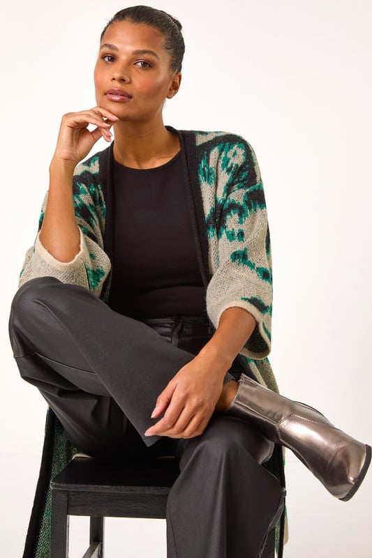 Abstract Print Knit Cover Up from Roman. Stay stylish and warm with this abstract knit cover up, perfect for the Autumn/Winter season. Designed with an eye catching abstract knit pattern, this cover up features an easy edge to edge front and chic short sleeves for a versatile look. Layer it over a long sleeve top and jeans for a fashionable and cosy outfit.