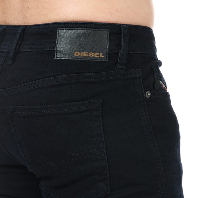 Mens Diesel Sleenker -X Skinny Fit Jeans in navy.- 5-pocket construction. - Full branded button fly.- Six belt loops on the waistband.- Top stitch detail.- Branded strip across small pocket.- Signature Diesel logo patch on the reverse right side of the waistband.- Skinny fit. - 98% Cotton  2% Elastane.- Ref: 00SWJE0095X01