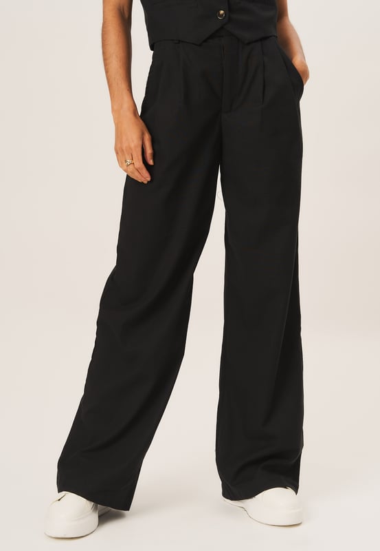 Elevate your wardrobe with our Tailored Cotton Wide Leg Trousers. Made from high quality cotton, these trousers are both comfortable and stylish. The wide leg design adds a touch of fashion to your look, perfect for any occasion.