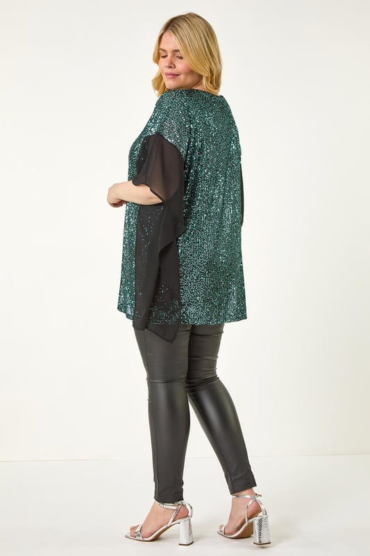 Curve Full Sequin Chiffon Overlay Top from Roman. Unleash your inner glam goddess with the sequin overlay top! This dazzling top features an all over sequin design with a delicate chiffon trim overlay, adding a touch of elegance. The V-Neckline and below hip length create a flattering silhouette that's perfect for special occasions. Pair it with pleather trousers and heeled boots to create a show-stopping party look that will turn heads all night long!