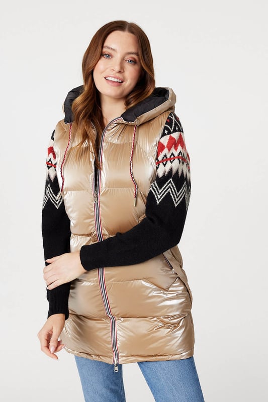 Add a puffer vest like this one to a transitional season wardrobe. With a hood, zip front closure, pockets with a zip detail and a longline fitted shape dropping to thigh length. Layer over your favourite knit pullover and jeans for a look that's perfect for when the weather turns colder.