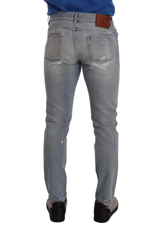 100% Authentic Dolce \u0026 Gabbana tattered denim jeans.\n  Crafted from cotton.\n  Zipper and button closure.\n  Straight fit.\n  Light blue color.\n  Regular fit.\n  Made in Italy.\n  Logo details.\n  Material: 100% Cotton.