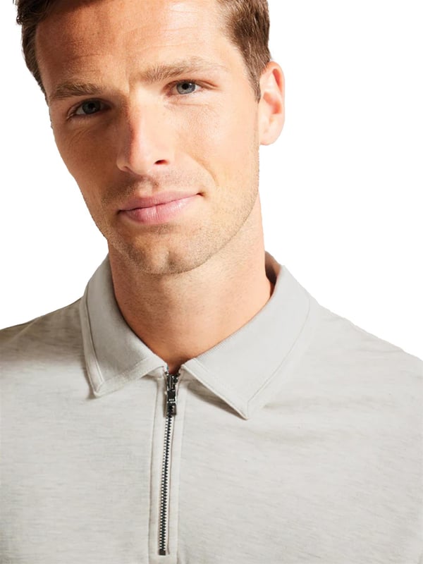 The Ted Baker men's Karpol long sleeve polo shirt in navy offers a refined take on a wardrobe staple. Crafted from a soft modal blend fabric, this polo delivers exceptional comfort and a luxurious feel against the skin. It features a classic collar and a zip placket, adding a modern twist to the timeless design. The long sleeves make it a versatile piece, suitable for both casual and smart-casual looks, providing style and ease for any occasion.