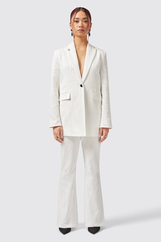 Refresh your wardrobe with the Fiore Trouser in White. Cut to a flared fit it features a jacquard print for added texture and made from a cotton blend to keep you cool. With its classic tailoring it's a great new addition to your collection. Pair it with the matching Fiore Jacket in White to complete the full look.
Model is 5'6" (168cm), chest 32" (81cm), waist 27" (69cm) and wearing a size 8.