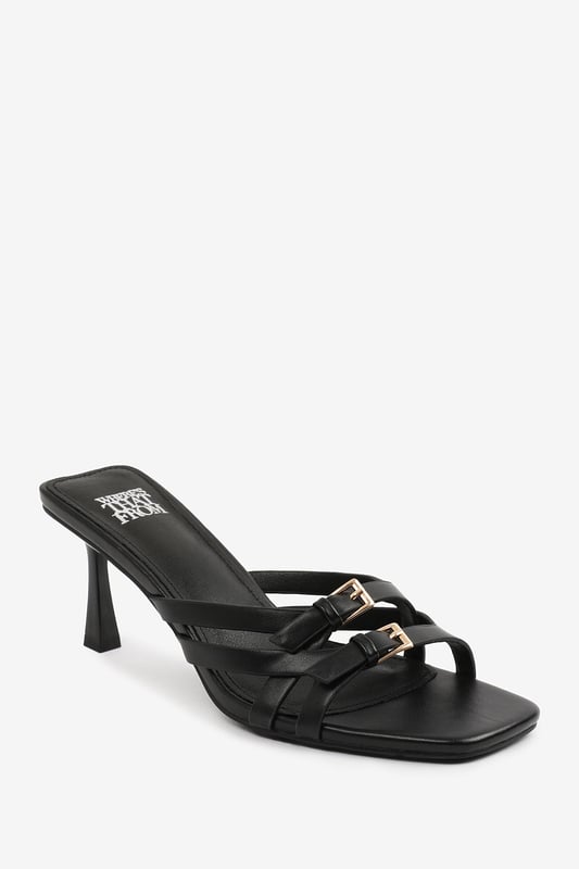 Step up your style with these Torigh Cross Over Buckle Details Strap Heel. Perfect for casual outings or dressy events, these sandals combine modern elegance with lasting comfort, making them a must-have addition to your wardrobe.

Key Features: 
Durable Construction: Crafted with high-quality faux leather, these sandals are designed to last. The sturdy heel and durable straps provide reliable support, ensuring they can withstand regular wear without compromising style.
Chic Design: The multi-strap design with subtle metallic accents exudes elegance and sophistication. The square toe and slender heel add a modern, fashion-forward touch that enhances their timeless appeal.
Comfortable Fit: Featuring a padded insole and a balanced heel height, these sandals provide all-day comfort without sacrificing style. The open design ensures breathability and ease of wear, making them perfect for any occasion.

Specifications:
o   Material: High-quality faux leather
o   Heel Type: Slender heel
o   Closure: Slip-on design for convenience

Elevate your footwear collection with these Torigh Cross Over Buckle Details Strap Heel. Combining chic design, durable construction, and superior comfort, they are perfect for making a statement wherever you go!