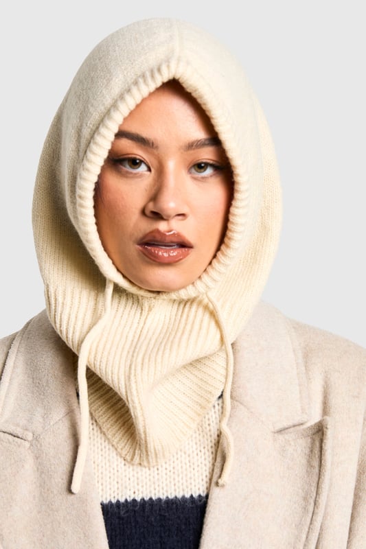 Cosy knitted balaclava-style hat
        Ribbed texture for added warmth
        Adjustable drawstring for a customised fit
        Extended neck coverage for extra protection
        Versatile design suitable for various winter activities
    
    Embrace the chilly weather with this snug and stylish balaclava-style hat from Boohoo. Perfect for those who crave both fashion and function, this piece offers comprehensive coverage from the crown of your head to your neck. The ribbed knit texture not only adds visual interest but also traps heat effectively, ensuring you stay toasty even on the coldest days. Style it with a chunky jumper and your favourite coat for a coordinated winter ensemble. Whether you're heading to a casual brunch with friends or embarking on a winter walk, this versatile hat adapts effortlessly to various occasions. Its neutral hue allows for easy pairing with your existing wardrobe, making it a must-have accessory for the fashion-forward woman who doesn't compromise on comfort.