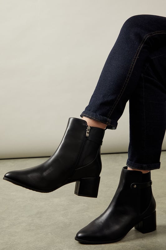 Wide fit design for enhanced comfort
        Elastic gusset for easy slip-on
        Medium block heel measuring between 5 and 6.5cm
        Sleek ankle-length silhouette
        Versatile day-to-night style
    
    Step out in style and comfort with these sophisticated Ahio ankle boots from Wallis. Crafted with a wide fit and featuring an elastic gusset, these boots offer both ease and elegance. The medium block heel, measuring between 5 and 6.5cm, provides a perfect balance of height and stability. Ideal for the woman who values both fashion and function, these boots transition seamlessly from day to night. Pair them with tailored trousers and a crisp blouse for a polished office look, or style them with a flowing midi dress for an evening out. The versatile design makes these boots a wardrobe essential, suitable for various occasions from casual outings to more formal events. With their timeless appeal and practical features, these Wallis boots are set to become your go-to footwear for any season.