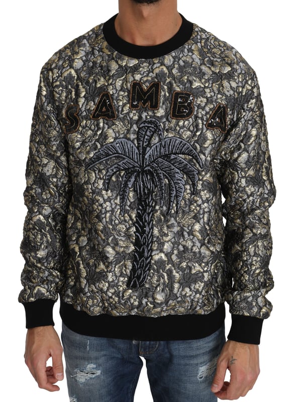 Dolce \u0026 Gabbana Jacquard Palm Tree Crewneck-tröja\n  100% äkta och helt ny med taggar\n  Pullover med crewneck-design\n  Flerfärgad palett med nyanser av grått och guld\n  SAMBA Jacquard Palm Tree-motiv\n  Logotypdetaljer\n  Tillverkad i Italien\n  Hantverk av hög kvalitet\n  Materialets sammansättning: 54% Polyester 17% Silke 17% Nylon 12% Metallfiber\n  Finns i märkesstorlek IT46 / US36 (passar storlek S)\n  Perfekt komplement till alla garderober\nMaterial: 54% Polyester 17% Silke 17% Nylon 12% Metallfiber