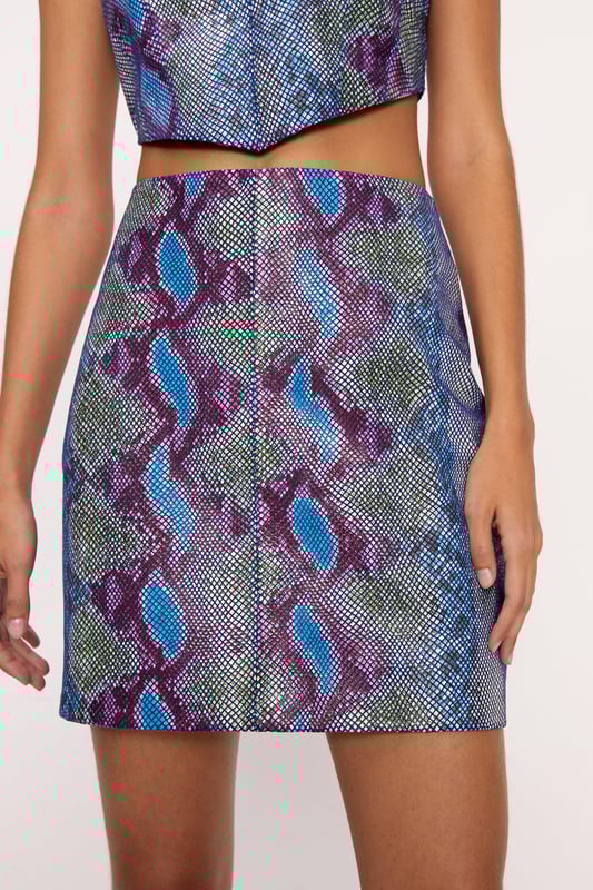 No snakes allowed. Feel confident in our leather skirt, made with high quality real leather fabric, with a flirty straight fit and a head turning snake print with metallic foiled details. Styles well with boots or heels for an evening look that will turn heads, whether you're heading out for date night or hitting up happy hour. Real Leather Snake Foil Pelmet Skirt High Quality Real Leather Unique Snake Print Shimmering Foil Details Flattering Straight Fit Zip Fastening in Back Model wears a size M (US size 6/UK size 10).