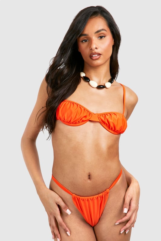Plunge neckline for a daring look
        Ruched cup detail adds texture and interest
        Adjustable spaghetti straps for a customised fit
        High-cut leg design elongates the silhouette
        Stretchy fabric ensures comfort and flexibility
    
    Make a splash this summer with our Tall geraffter Bikini mit Cup-Detail. This striking two-piece is designed to turn heads at the beach or poolside. The plunging neckline and ruched cup detail create a flattering silhouette, while the high-cut leg design elongates your frame for a leggy look. Perfect for those sun-soaked getaways or lazy days by the pool, this bikini is a must-have for your holiday wardrobe. Pair it with oversized sunglasses and a wide-brimmed hat for ultimate beach glamour, or throw on a sheer kaftan for an effortlessly chic look as you stroll along the shoreline. Whether you're lounging on a sun-drenched beach or sipping cocktails at a pool party, this bikini will ensure you stand out for all the right reasons.