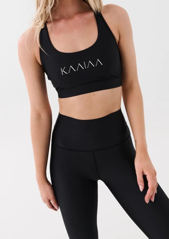 Scoop neck sports bra with a racer style back. Built in elasticated underbust support. KAAIAA logo print at front and back. P.E Nation logo print at back
