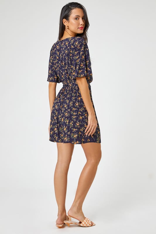 Ditsy Floral Print Playsuit from Roman. Enjoy the light and airy summer vibes with this ditsy floral print playsuit. Designed with a v neckline and short sleeves, this style is the perfect addition this season. Pair it with a cross body bag, sandals or trainers for those day meals out with friends and family. Why not bring a cardi along with you, perfect for the those fresh evenings out by the beach, what-ever the weather, where-ever you go, this little number is an easy go-to!