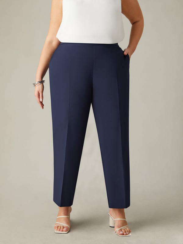 In classic navy, these trousers are cut from a woven fabric thats sturdy but comfortable to wear. With a flattering tapered leg, they have a tailored fit with side splits at the leg cuffs. A partially elasticated waist with a side zip closure adds comfort while ensuring the perfect fit, making these the perfect elevated trousers for any wardrobe.