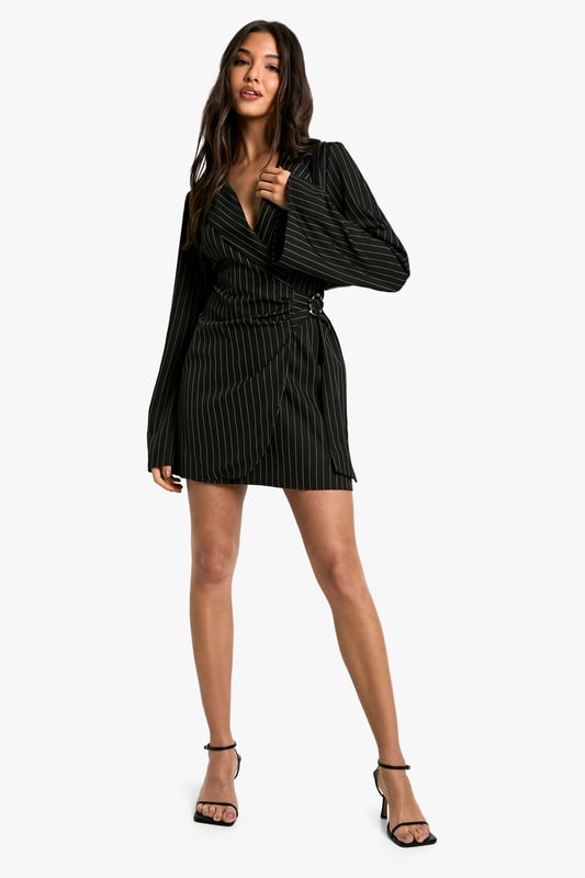 Striking pinstripe pattern for a bold, sophisticated look
        Wrap-style neckline adds a feminine touch
        Unique buckle detail at the waist for added interest
        Flared sleeves create a dramatic silhouette
        Versatile blazer dress design perfect for day-to-night transitions
    
    Make a statement in this eye-catching blazer dress from Boohoo. The pinstripe pattern adds a touch of classic sophistication, while the wrap-style neckline and buckle detail at the waist create a flattering, feminine silhouette. The flared sleeves add drama and movement to the overall look. Perfect for a night out with friends, this versatile piece can be dressed up or down. Pair it with strappy heels and statement earrings for a chic evening ensemble, or layer it over a turtleneck with ankle boots for a stylish daytime outfit. The blazer dress design offers endless styling possibilities, making it a must-have addition to your wardrobe. Whether you're heading to drinks at a trendy bar or dancing the night away at a club, this dress will ensure you stand out from the crowd.