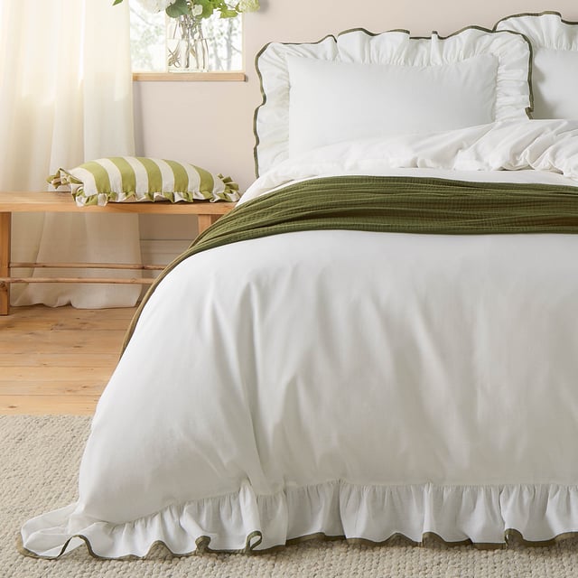 Transform your bedroom into a serene retreat with the Blousey Pillowcases. Crafted from 100% cotton sateen with a luxurious 180 thread count, these pillowcases are as soft as they are stylish. A subtle yet elegant ruffled trim, accentuated by a delicate piped detail, adds a touch of timeless sophistication to your bedding ensemble. Perfect for layering with textured throws or cushions, they create an effortlessly cosy yet refined aesthetic that complements both minimalist and relaxed interiors. These pillowcases not only enhance your bedroom’s visual appeal but also provide a breathable, comfortable surface for restful sleep.