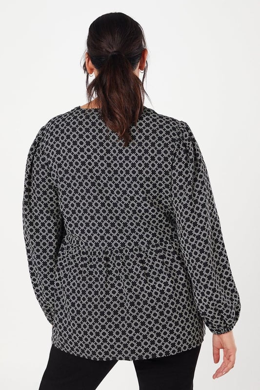 Striking geometric print for a modern, eye-catching look
        Button-through front design for easy wear and versatility
        Flattering peplum silhouette to accentuate the waist
        Voluminous long sleeves for a touch of drama
        V-neckline to elongate the neck and add a feminine touch
    
    This Dorothy Perkins peplum top radiates contemporary charm with its captivating geometric print. The button-through design offers both style and practicality, allowing for effortless dressing and the option to adjust your look. The peplum silhouette gracefully cinches at the waist before flaring out, creating a flattering shape for various body types. Style this versatile piece with slim-fit trousers and white trainers for a chic daytime ensemble perfect for brunching with friends or attending a casual family gathering. For a more polished look, pair it with dark tailored trousers and ballet flats, ideal for those days when you want to feel put-together without compromising on comfort. The long, billowy sleeves add a touch of drama, making this top a standout choice for your wardrobe that transitions seamlessly from day to night.