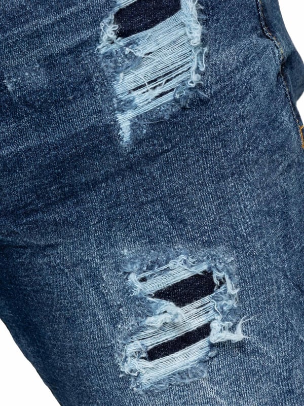 Upgrade your denim collection with Enzo Men's Distressed Ripped Jeans. Designed for the modern man, these jeans combine style and comfort with a classic straight leg cut and versatile 5-pocket design. The stretch fabric ensures a perfect fit and ease of movement. Featuring a zip fly fastening, distressed rip & repair detailing, and a branded back patch, these jeans add a rugged touch to any outfit. Ideal for casual outings or nights out, they effortlessly blend style and functionality.
