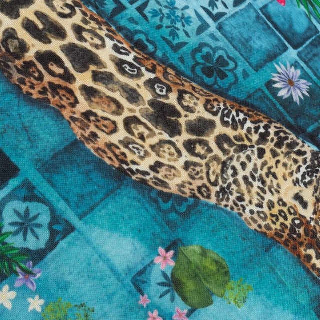 Elevate your outdoor space with the Majorelle Leopard Moroccan Piped Outdoor Cushion, a masterpiece of luxury and detail. This cushion features a hand-painted design capturing a majestic leopard gliding through the serene waters of a Moroccan Riad, framed by intricate tiles and lush palms. The soft-touch material, specially treated for outdoor durability, promises both style and resilience. Matching piping adds a refined finish, ensuring every detail is considered. Ideal for those who cherish artisanal craftsmanship and seek elegance in their surroundings, this cushion transforms any setting into an oasis of calm and sophistication.