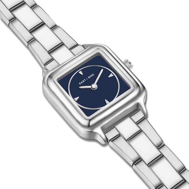 GENERAL INFORMATION:  • Targetgroup: Female  • Wristwatch: No Special Functions  • Display: analogue  • Weight of watch w/o box (gr.) - approx.: 59,0  MOVEMENT:  • Movement: Quartz  • Term of Movement: 2025  • Origin of movement: Japan  BRACELET:  • Material of bracelet/strap: Stainless steel  • Plating of bracelet/strap: None  • Finishing of bracelet/strap: Smooth  • Finishing/Decoration of bracelet/strap: None  • Clasp/Closure/Buckle: Security-folding clasp  • Color of bracelet/strap: Silver  • Length of bracelet/strap (mm) approx.: 210,0  • Width of bracelet/strap (mm) approx.: 13,8  • Style/Design of bracelet/strap: Link bracelet  • Bracelet/strap adjustable?: Yes  CASE:  • Shape of case: Square  • Size/Diameter of case in mm . approx.: 25,0 x 32,0  • Height of case in mm: 8,1  • Case material: Metal (Alloy)  • Surface of case: Polished  • Bezel/Topring: Fixed  • Finishing/Decoration of case: None  • Material of case back: Stainless steel  • Lock of case back: No screwed-in crown  • Color of case: Silver  • Coating/Plating (Case): None  • Type/Form of crystal: Flat  • Material of crystal: Mineral crystal  DIAL:  • Size jewelry care cloth: Hour, Minute  • Indices: Line indices  • Material of dial: Mother of Pearl (MOP)  • Structure/pattern of dial: Flat  • Color of dial: Blue  PUSHER, CROWN, HAND:  • Pusher: None  • Corrector: No  • Crown: No screwed-in crown  • Type of hands: Pole hand  • Luminescent (hands): No  PACKAGING & SCOPE OF DELIVERY:  • Box: Yes  • Service booklet: Yes  • Manual: Yes