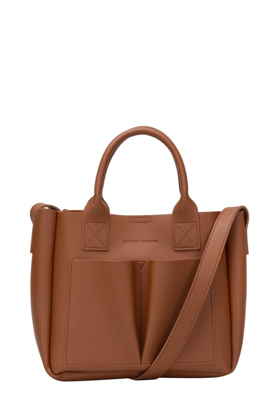 This dreamy mini grab bag is perfect for adding a contemporary look to your outfit. The soft PU exterior and contrast unlined interior gives it a premium finish and the gunmetal hardware adds quality. The subtle Claudia Canova blind debossed logo and intricate stitch detail finishes the look. Inside is a secure zip top pouch, which can be removed by unfastening the snap clasp buttons, perfect to use as a portable makeup bag or to keep valuable items more secure. Features: , soft pu outer, Unlined Interior, Claudia and Canova Blind Deboss Logo, 2 x Short Grab / Tote Handles, Adjustable longer shoulder strap, Magnetic snap claps opening to the main compartment, Removable zip top pouch (Meausure 215W x 152H x 50D), 2 x Quick access slip pockets in front Style Ref: 84608 TAN