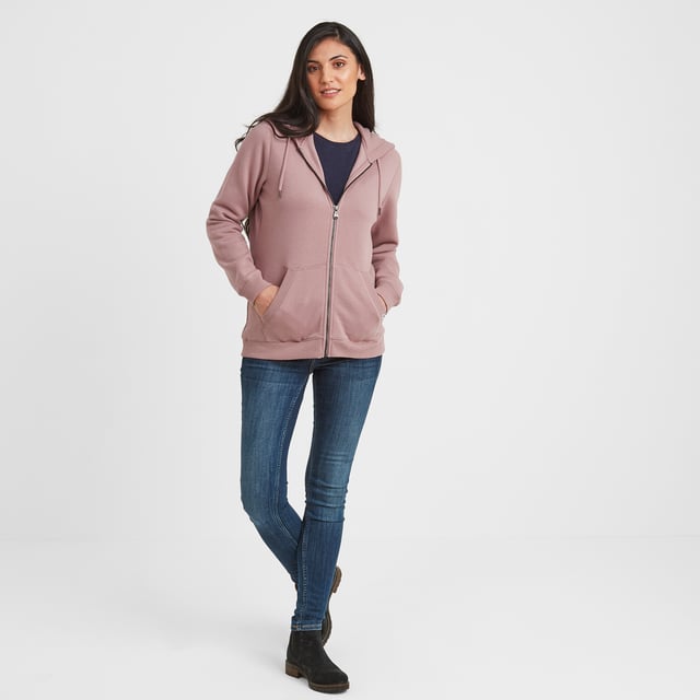 A wardrobe staple, our Mia zip through hoody comes in a supersoft brushed back fleece finish, so soft and cosy that you won't want to take it off. A layer you can easily throw on for a blustery walk across the moors, popping to the gym or meeting up with friends, giving you much needed insulation on chilly days. This classic hoody has a premium feel and keeps its shape for years to come thanks to generous ribbing to the cuffs and hem and the opening of the snug, split kangaroo pocket. The double fabric drawcord hood is warm and cosy and keeps the wind out of your ears. Mia comes in colours inspired by wild moorland heather, celebrating our proud Yorkshire heritage, and is finished with a small branded woven Truth Over Glory label on the pocket.