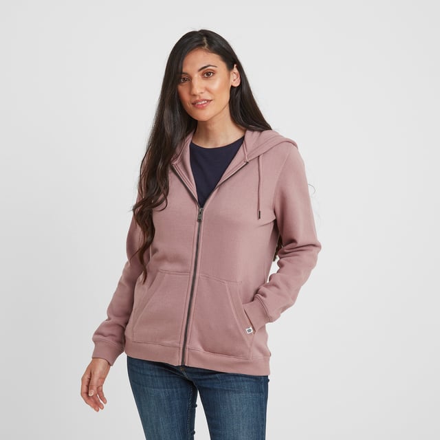 A wardrobe staple, our Mia zip through hoody comes in a supersoft brushed back fleece finish, so soft and cosy that you won't want to take it off. A layer you can easily throw on for a blustery walk across the moors, popping to the gym or meeting up with friends, giving you much needed insulation on chilly days. This classic hoody has a premium feel and keeps its shape for years to come thanks to generous ribbing to the cuffs and hem and the opening of the snug, split kangaroo pocket. The double fabric drawcord hood is warm and cosy and keeps the wind out of your ears. Mia comes in colours inspired by wild moorland heather, celebrating our proud Yorkshire heritage, and is finished with a small branded woven Truth Over Glory label on the pocket.