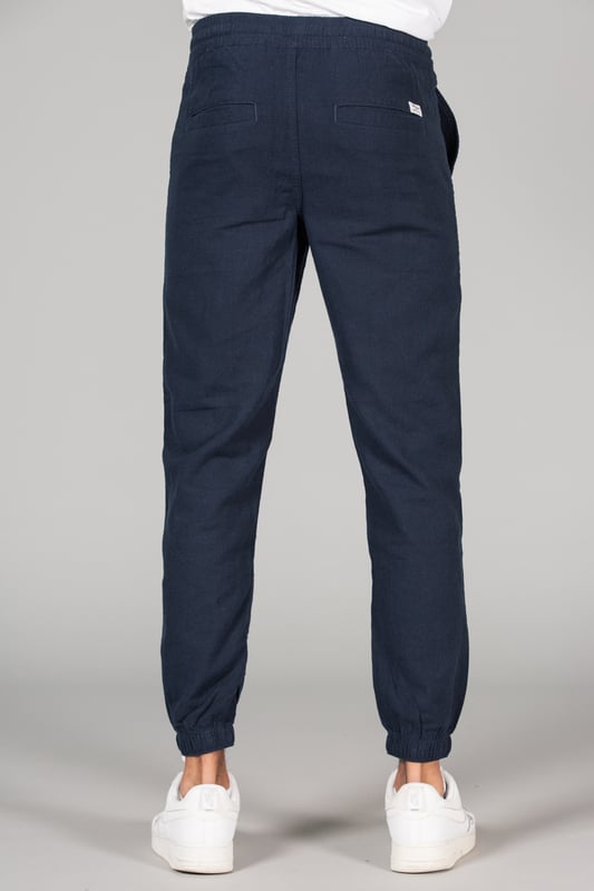 Navy Linen Blend Classic Fit Trousers Upgrade your wardrobe with these linen trousers from Tokyo Laundry, featuring a classic fit and drawstring waist for added comfort. Made from a breathable blend of linen and cotton, these trousers are perfect for both casual and formal occasions. Machine washable for easy care, they are a versatile addition to any wardrobe.