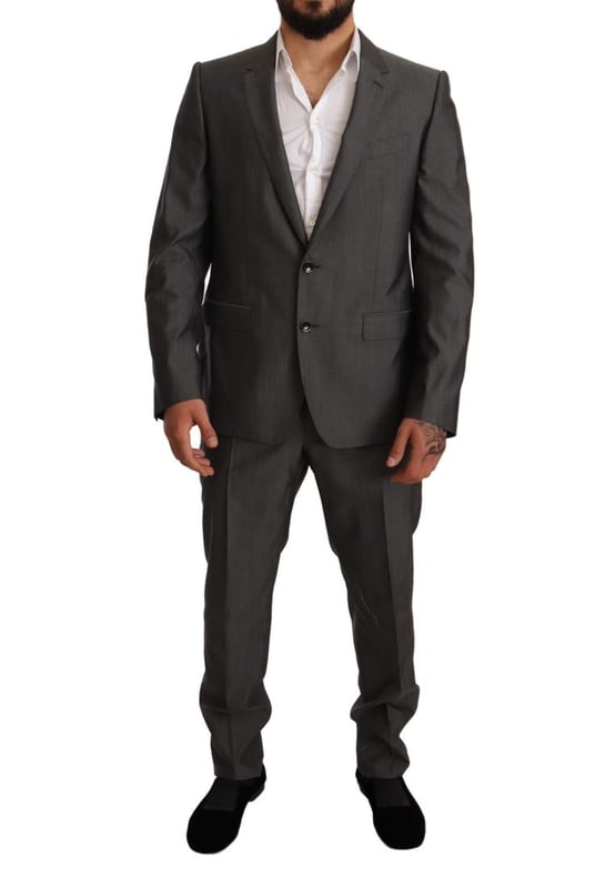 100% Authentic Dolce & Gabbana Suit
  Model: MARTINI
  Style: Single breasted 2 piece suit; includes blazer and pants
  Color: Gray metallic
  Closure: Two button closure
  Fitting: Slim fit
  Two inside pockets
  One open vent in the back
  3-way pants zipper closure
  Logo details
  Made in Italy
  Material: 65% Wool 35% Silk
  Lining: 100% Rayon