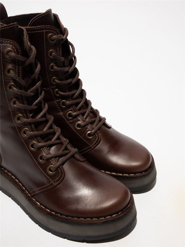 The Fly London RAMI043FLY Casual Lace-Up Ankle Boots offer a stylish yet practical addition to your footwear collection. Crafted from high-quality leather with a soft microfiber lining, these boots provide all-day comfort and abrasion-free wear. The classic lacing system is paired with a convenient side zip for easy on/off. Featuring a foam-padded, microfiber-lined footbed and a durable rubber wedge sole. These boots ensure cushioning, grip, and traction, Perfect for everyday use, Premium leather upper with soft microfiber lining, Lace-up with side zip for easy wear Cushioned, Foam-padded footbed, Durable rubber wedge sole for grip, Flat heel for all-day comfort.