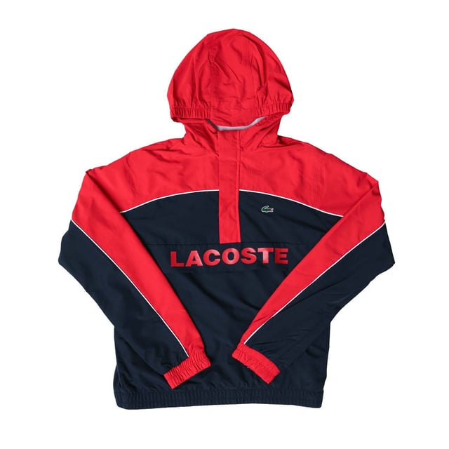 Junior Lacoste Water- Repellent Windbreaker Jacket in red navy.- Hood with adjusting system at back and front.- Half zip fastening.- Mesh lining.- Elasticated cuffs and hem.- 100% Polyester.- Ref: BJ9809528