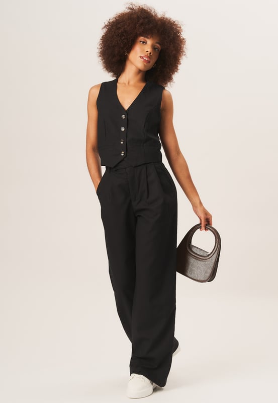 Complete your sophisticated look with our Tailored Single Breasted Waistcoat. Made with high-quality materials, this waistcoat adds a touch of elegance to any outfit. Pair it with our matching suit for a polished and fashionable appearance.