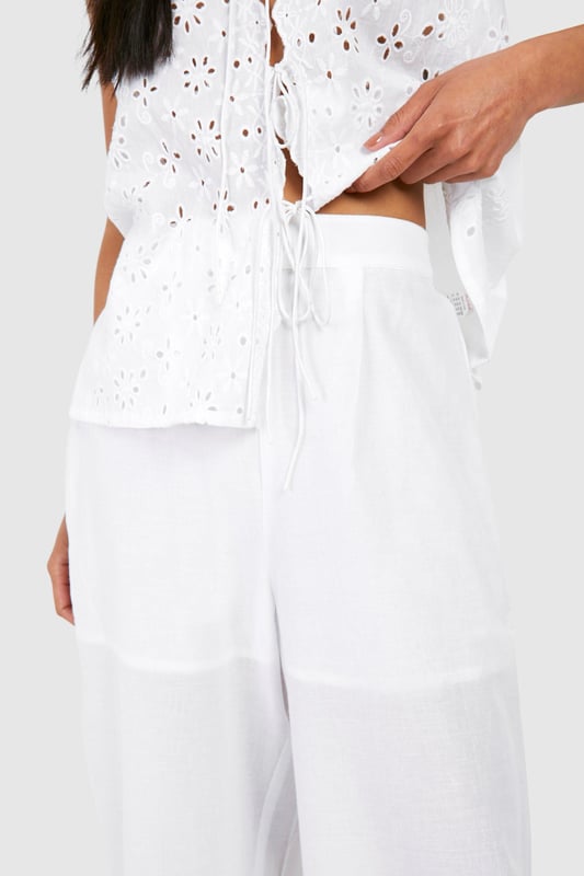 Broderie Straight Leg Trousers Straight-leg trousers with intricate eyelet pattern
High-waisted design for a flattering silhouette
Sleeveless top with daring lace-up front detail
Wide-leg cut for effortless movement and comfort
Versatile two-piece set perfect for mix-and-match styling
Embrace laid-back chic with this eye-catching two-piece set from Boohoo. The straight-leg trousers feature an alluring eyelet pattern that adds texture and visual interest to your look. Paired with a sleeveless top boasting a daring lace-up front, this ensemble strikes the perfect balance between comfort and style. The high-waisted design of the trousers elongates your silhouette, while the wide-leg cut ensures unrestricted movement. Ideal for casual outings, family gatherings, or relaxed weekends, this set can be dressed up or down with ease. Style with flat sandals and a clutch for a daytime look, or swap for wedges and statement earrings for an evening affair. The versatility of this set allows for endless styling possibilities - wear the pieces together for a coordinated look or separately to create multiple outfits from your wardrobe.