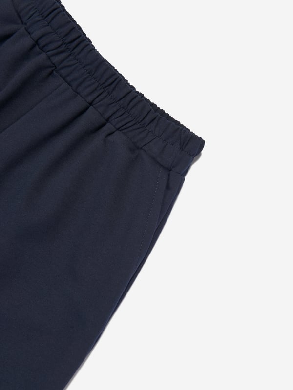 Californian label Mama Luma depict beautiful designs via their ethically sourced fabrics. These girls navy joggers  are reflective of the label's fine detailing and handmade construction. They showcase a sleek elasticated waistband and side pockets. ‚ 50% Viscose, 45% Polyester, 5% Elastane