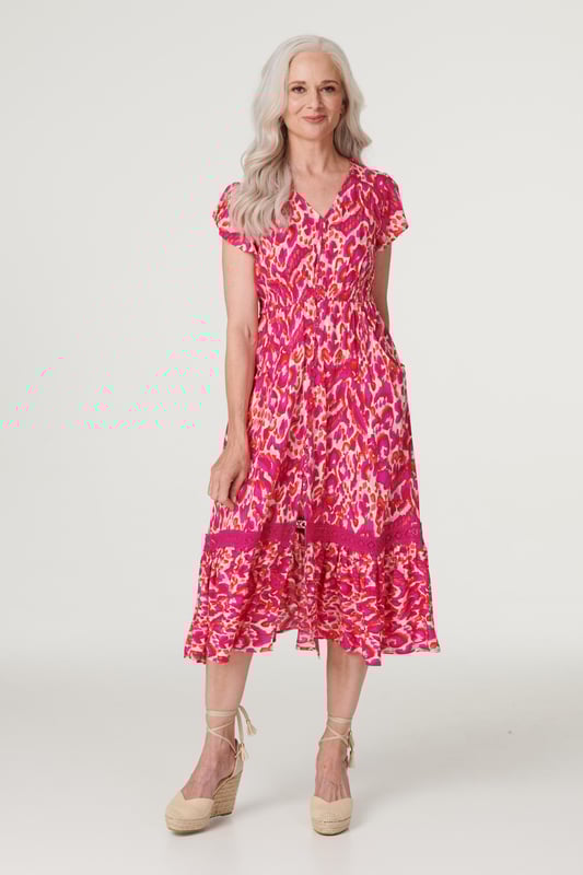 Add a statement maxi dress to your closet with this vibrant printed a-line dress. With a V-neck, a button front, frilled cap sleeves, pockets and a crochet detail tiered midi skirt. Style with blush heels and a clutch bag for a garden wedding or dress down on holiday with sandals.