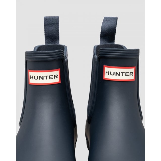 Size/Fit Summary: True to size, Regular fit which features new engineered improvements. If you are in-between sizes or want to wear a thick sock, it is recommended to size up.
The Hunter Original Chelsea Boot has been re-engineered for an improved fit and all-day comfort. A wider ankle circumference, and an increased curve in the heel and around the Achilles tendon delivers an even more comfortable fit.
The new and improved Hunter Original Chelsea Boot has an even more optimum fit to maximise all-day comfort. Ready for rain, each boot is handcrafted from natural rubber and vulcanised for superior protection. Retaining the iconic features of a traditional Chelsea, it features elasticated-gussets and has a nylon pull-tab to make stepping into the boot easy. In a classic black matte, these men's waterproof Chelsea's are a wet weather wardrobe essential.
We recommend that all Hunter Chelsea boots be worn with Hunter Chelsea socks, which have been technically designed to protect the wearer's skin from contact with rubber in specific areas.

Waterproof
Handcrafted
Waterproof
Polyester lining
Rubber outsole with Hunter Original tread pattern
Elastic side gussets and nylon pull-tab
Crafted from natural vulcanised rubber with a matte finish