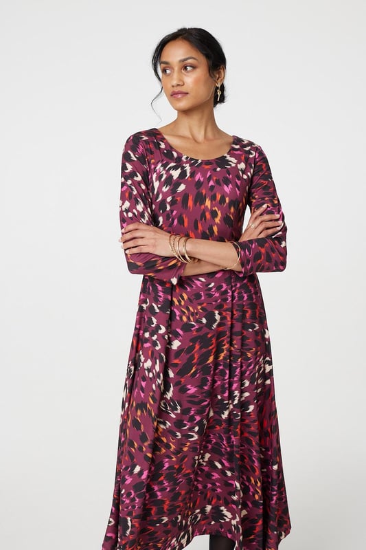 Add a vibrant animal print to your new season closet with this anima print midi dress. With a round neck, 3/4 sleeves, a hanky hem and a midi skirt. Style with strappy hees for a special event or pair with tights and block heeled boots to beat the chill.