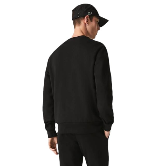 Stay warm and stylish in the Lacoste Fleece Crew Neck Sweatshirt. Made with brushed organic cotton fleece, this sweatshirt offers a soft and comfortable fit. The classic fit and high neck provide natural ease, while the signature crocodile embroidery adds a touch of sophistication. A bestseller from the sportswear experts since 1933.